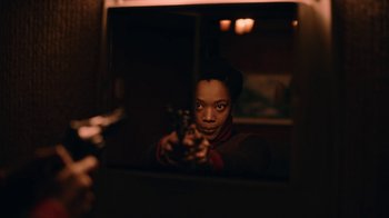 Movie still from “The End of the F***ing World” (2017), directed by Jonathan Entwistle – A woman holding a gun in front of a mirror; Medium shot, Over the shoulder angle