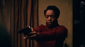 Movie still from “The End of the F***ing World” (2017), directed by Jonathan Entwistle – A woman in a red sweater holding a gun; Medium shot, Low angle
