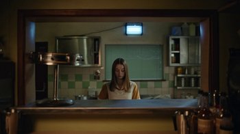 Movie still from “The End of the F***ing World” (2017), directed by Jonathan Entwistle – A woman is standing in front of a mirror in a kitchen; Medium shot, Low angle