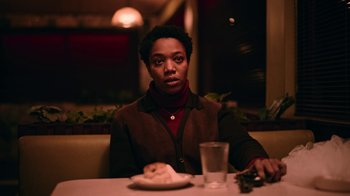 Movie still from “The End of the F***ing World” (2017), directed by Jonathan Entwistle – A person sitting at a table with a plate of food; Medium shot, Low angle