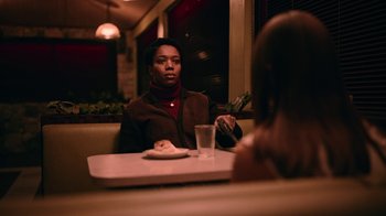 Movie still from “The End of the F***ing World” (2017), directed by Jonathan Entwistle – A woman sitting at a table in front of another woman; Medium shot, Over the shoulder angle