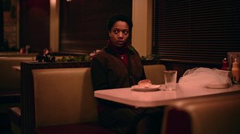 Movie still from “The End of the F***ing World” (2017), directed by Jonathan Entwistle – A woman sitting at a table in a restaurant; Medium shot, Over the shoulder angle
