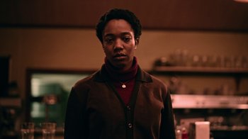 Movie still from “The End of the F***ing World” (2017), directed by Jonathan Entwistle – A woman standing in a room with her eyes wide open; Medium shot, Low angle