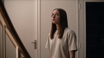 Movie still from “The End of the F***ing World” (2017), directed by Jonathan Entwistle – A woman standing in front of a mirror looking up; Medium shot, Low angle