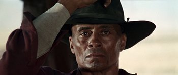 Movie still from “Once Upon a Time in the West” (1968), directed by Sergio Leone – A person wearing a hat; Close Up shot, Low angle