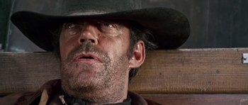 Movie still from “Once Upon a Time in the West” (1968), directed by Sergio Leone – A man wearing a hat; Close Up shot, Low angle