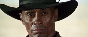 Movie still from “Once Upon a Time in the West” (1968), directed by Sergio Leone – A person wearing a hat; Close Up shot, Low angle