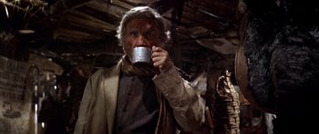 Movie still from “Once Upon a Time in the West” (1968), directed by Sergio Leone – An older man drinking a cup of coffee; Medium shot, Low angle