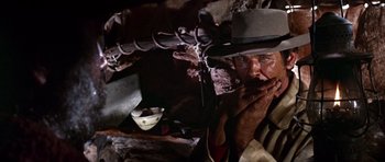 Movie still from “Once Upon a Time in the West” (1968), directed by Sergio Leone – A man with a hat and a chain around his neck; Close Up shot, Low angle