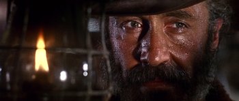 Movie still from “Once Upon a Time in the West” (1968), directed by Sergio Leone – A man with a beard and a hat; Extreme Close Up shot, Low angle