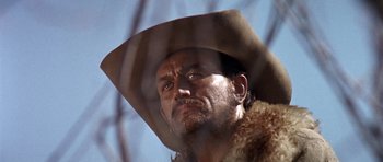 Movie still from “Once Upon a Time in the West” (1968), directed by Sergio Leone – A person wearing a cowboy hat; Close Up shot, Low angle
