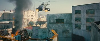 Movie still from “The Expendables 2” (2012), directed by Simon West – An image of a helicopter flying over a city; Extreme Wide shot, Low angle