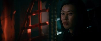 Movie still from “The Expendables 2” (2012), directed by Simon West – A person looking at the camera; Close Up shot, Over the shoulder angle