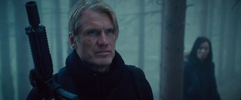 Movie still from “The Expendables 2” (2012), directed by Simon West – A person wearing a black jacket; Close Up shot, Low angle