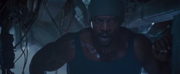 Movie still from “The Expendables 2” (2012), directed by Simon West – A person wearing a hat; Close Up shot, Low angle