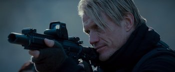 Movie still from “The Expendables 2” (2012), directed by Simon West – A person holding a camera; Close Up shot, Over the shoulder angle