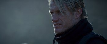 Movie still from “The Expendables 2” (2012), directed by Simon West – A person wearing a black jacket; Close Up shot, Over the shoulder angle