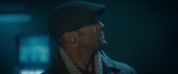 Movie still from “The Expendables 2” (2012), directed by Simon West – A person wearing a hat; Close Up shot, Low angle