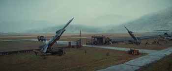 Movie still from “The Expendables 2” (2012), directed by Simon West – An old missile is sitting in the middle of a field; Extreme Wide shot, High angle