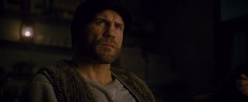 Movie still from “The Expendables 2” (2012), directed by Simon West – A person wearing a hat; Close Up shot, Low angle