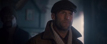 Movie still from “The Expendables 2” (2012), directed by Simon West – A person wearing a hat and a jacket; Close Up shot, Low angle