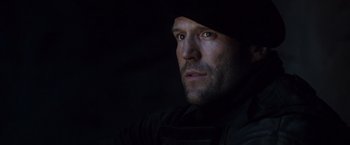 Movie still from “The Expendables 2” (2012), directed by Simon West – A person wearing a hat; Close Up shot, Low angle
