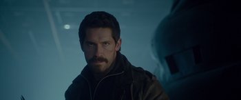 Movie still from “The Expendables 2” (2012), directed by Simon West – A person with a beard; Close Up shot, Over the shoulder angle