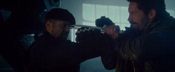 Movie still from “The Expendables 2” (2012), directed by Simon West – A man holding a pair of knifes in his hand; Close Up shot, Over the shoulder angle
