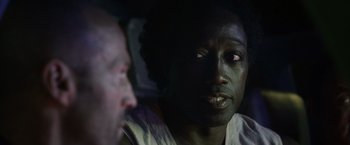 Movie still from “The Expendables 3” (2014), directed by Patrick Hughes – Two men are sitting next to each other in a dark room; Close Up shot, Over the shoulder angle