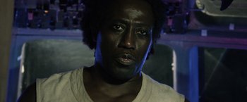 Movie still from “The Expendables 3” (2014), directed by Patrick Hughes – A person wearing a white t - shirt; Close Up shot, Low angle