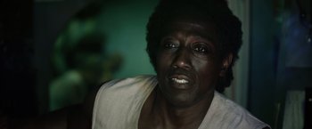 Movie still from “The Expendables 3” (2014), directed by Patrick Hughes – A person wearing a white t - shirt; Close Up shot, Low angle