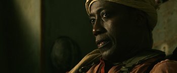 Movie still from “The Expendables 3” (2014), directed by Patrick Hughes – A person wearing a yellow hat; Close Up shot, Low angle