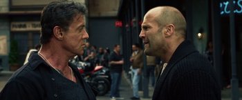 Movie still from “The Expendables 3” (2014), directed by Patrick Hughes – Two men are facing each other on the street; Close Up shot, Over the shoulder angle