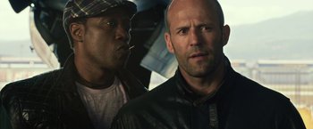 Movie still from “The Expendables 3” (2014), directed by Patrick Hughes – A man and a man with a hat and a leather jacket; Close Up shot, Low angle