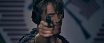 Movie still from “The Expendables 3” (2014), directed by Patrick Hughes – A person holding a gun; Close Up shot, Over the shoulder angle