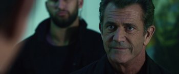 Movie still from “The Expendables 3” (2014), directed by Patrick Hughes – A man in a black shirt and a man in a black shirt; Close Up shot, Over the shoulder angle
