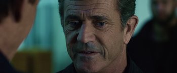 Movie still from “The Expendables 3” (2014), directed by Patrick Hughes – An older man with grey hair looking at the camera; Close Up shot, Over the shoulder angle