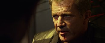 Movie still from “The Expendables 3” (2014), directed by Patrick Hughes – A person with blood on his face; Close Up shot, Low angle