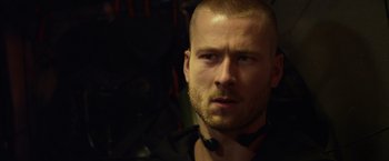 Movie still from “The Expendables 3” (2014), directed by Patrick Hughes – A person wearing a black shirt; Close Up shot, Over the shoulder angle