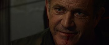Movie still from “The Expendables 3” (2014), directed by Patrick Hughes – A person with blood on his face; Close Up shot, Over the shoulder angle