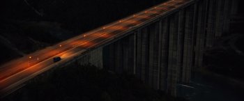 Movie still from “The Expendables 3” (2014), directed by Patrick Hughes – A long bridge with lights on the top of it; Extreme Wide shot, High angle