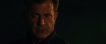 Movie still from “The Expendables 3” (2014), directed by Patrick Hughes – A person wearing a black shirt; Close Up shot, Low angle