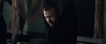 Movie still from “The Expendables 3” (2014), directed by Patrick Hughes – A man with a shaved head hanging from a ceiling; Close Up shot, Low angle