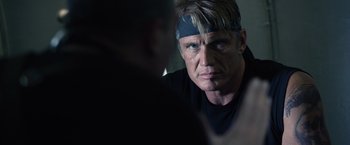 Movie still from “The Expendables 3” (2014), directed by Patrick Hughes – A person wearing a head band; Close Up shot, Over the shoulder angle