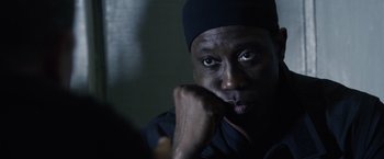 Movie still from “The Expendables 3” (2014), directed by Patrick Hughes – A person with his hand under his chin; Close Up shot, Over the shoulder angle