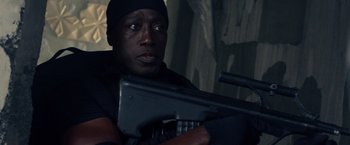 Movie still from “The Expendables 3” (2014), directed by Patrick Hughes – A man holding a gun while wearing a black hat; Close Up shot, Low angle