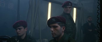 Movie still from “The Expendables 3” (2014), directed by Patrick Hughes – Two men in military fatigues and red hats; Medium shot, Low angle