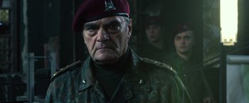 Movie still from “The Expendables 3” (2014), directed by Patrick Hughes – An older man in a military uniform with a beret; Close Up shot, Over the shoulder angle