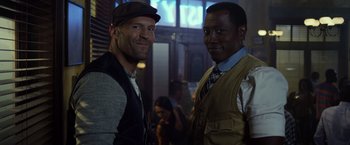 Movie still from “The Expendables 3” (2014), directed by Patrick Hughes – A couple of men standing next to each other; Close Up shot, Low angle