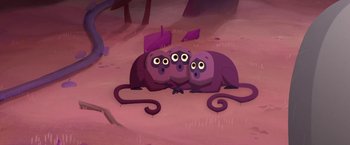 Movie still from “My Father's Dragon” (2022), directed by Nora Twomey – A group of three purple animals sitting next to each other on the ground; Wide shot, High angle
